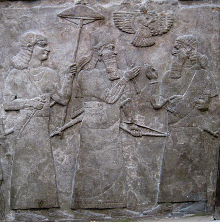 Ashurnasipal II receiving an oficial. Note the farohar-like symbol above the king