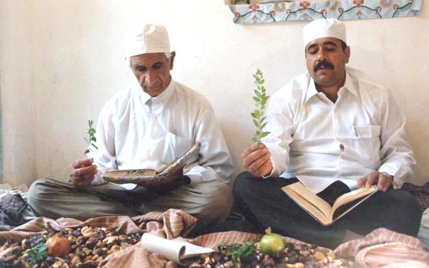 Iranian Priests reciting the Afringan / Afranami while holding a sprig during a gahanbar in Yazd, Iran