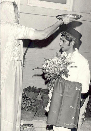 Bride's mother performs an achu-michu on the groom