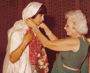 Aarti: groom's mother places a garland on the bride