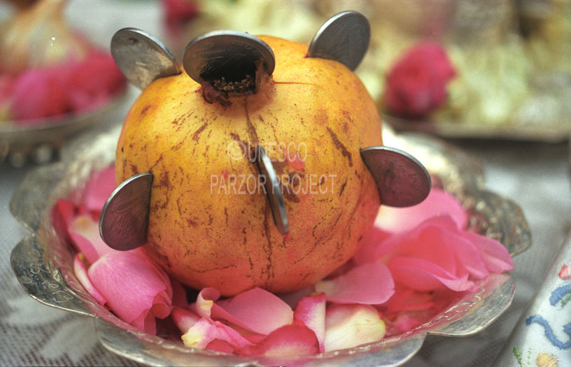 pomegranate fruit with coins inserted