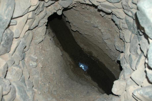 A look down the shaft to the water flowing through the kariz tunnel