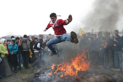 Kurds celebrating Nowruz by leaping over a bonfire